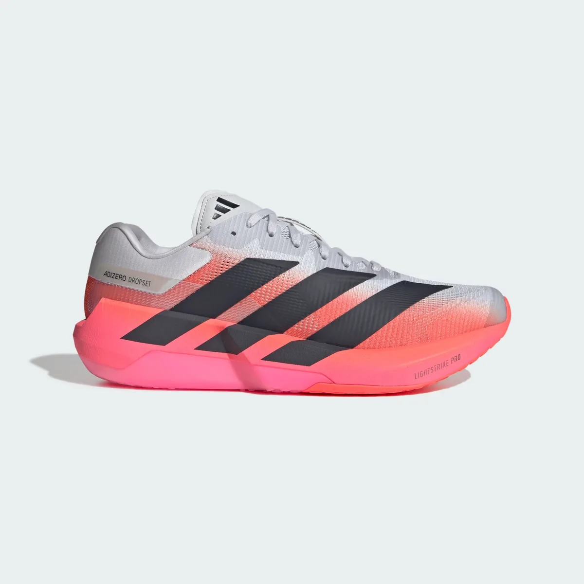 The adidas Adizero Dropset Pro in grey fading to coral pink, with black stripes.