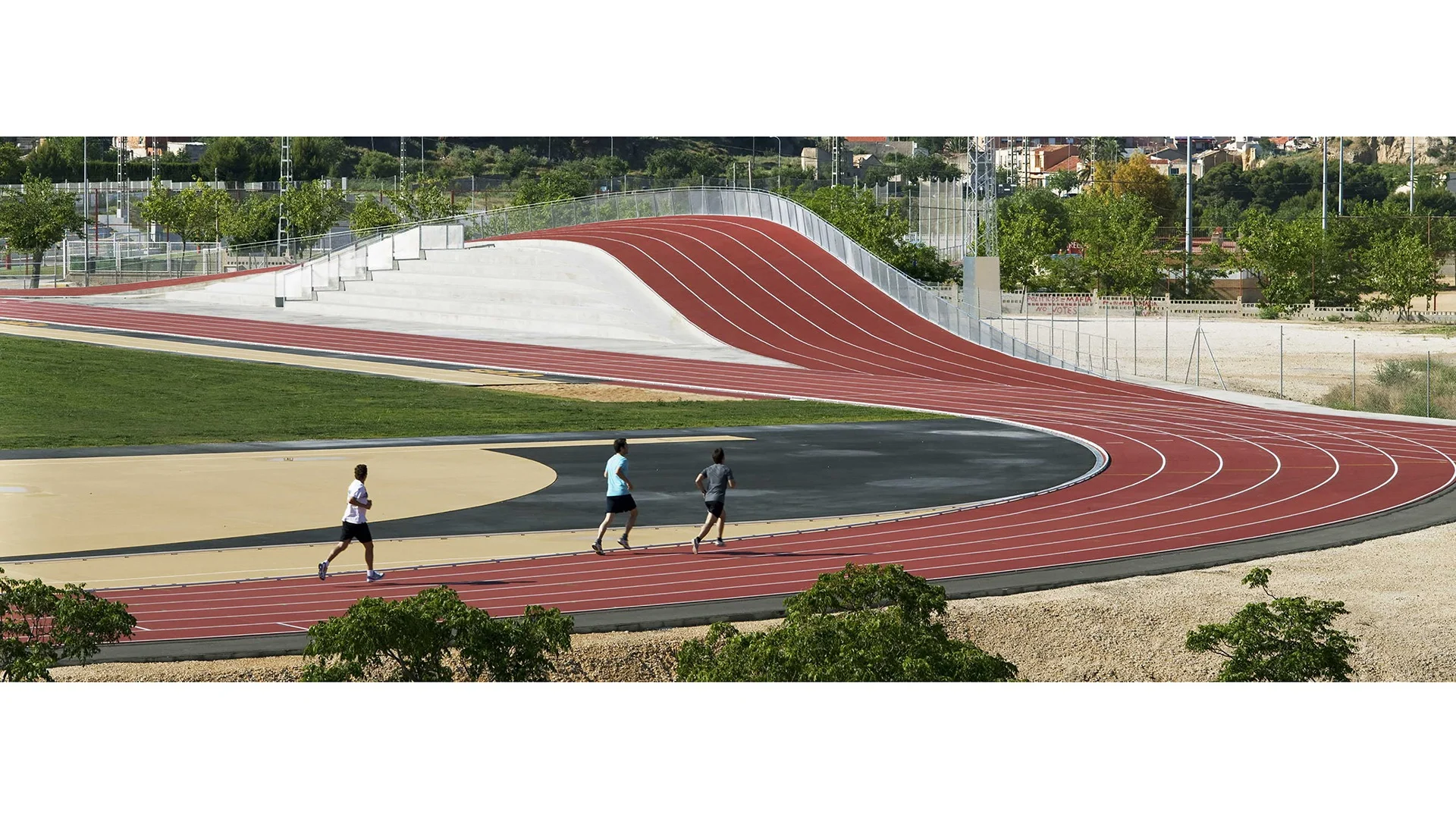 Runners approach the raised extension of the Elda track as it climbs over the changing rooms.